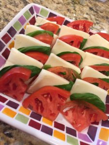 Layers of tomato, mozzarella, basil