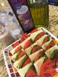 Tomato, basil, and mozzarella make a quick and easy caprese appetizer that's perfect for the hot summer!