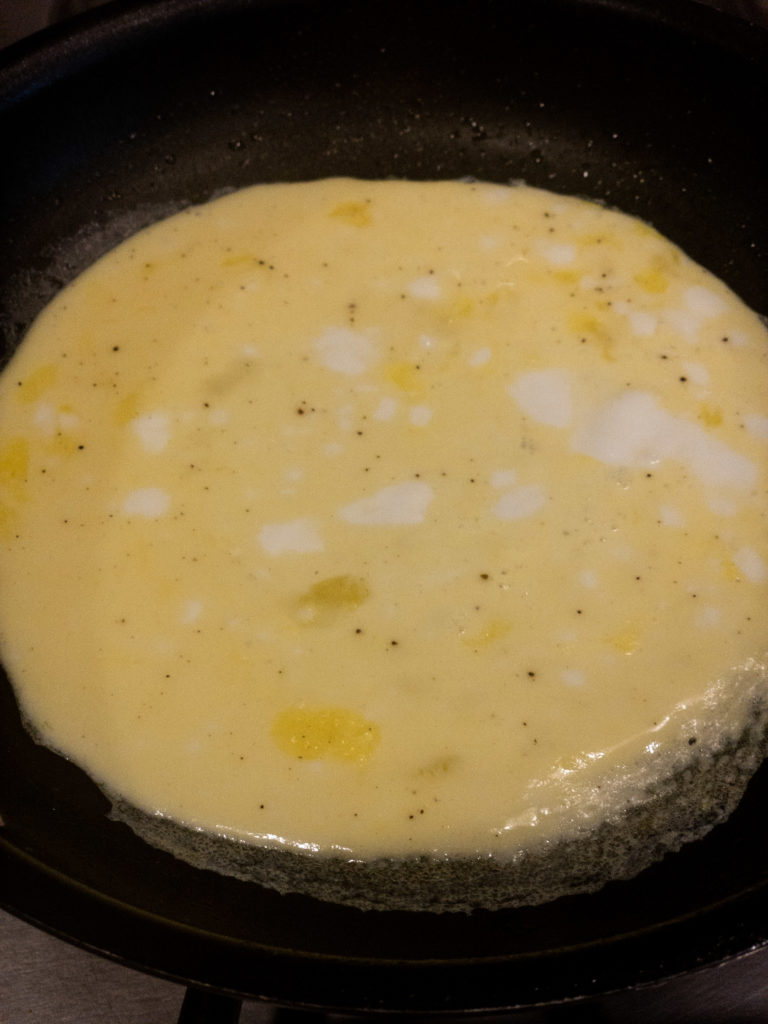 Scrambled eggs cooking for breakfast sandwiches